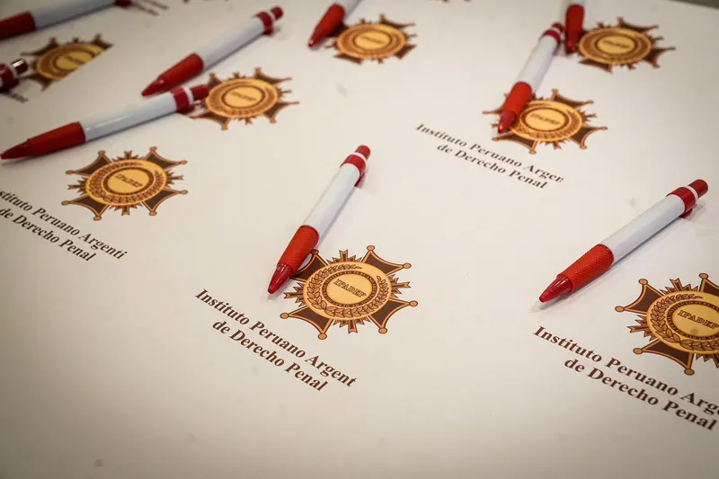 Lapiceros y papelería institucional con la medalla del Instituto Peruano Argentino de Derecho Penal